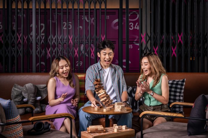 Guests enjoy games at the lounge area of Moxy Bangkok Ratchaprasong